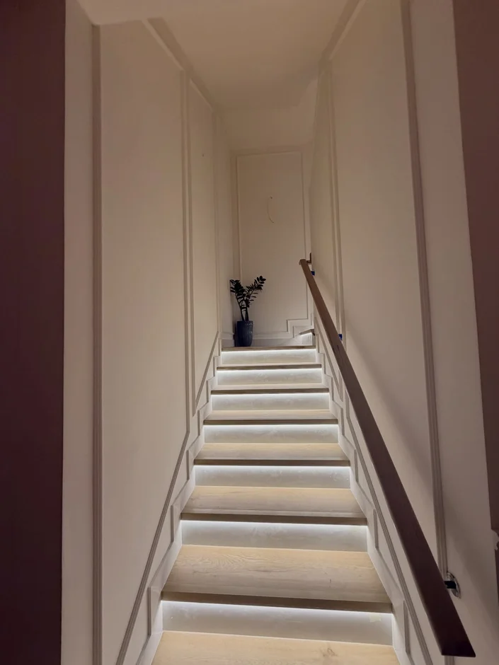 Elegant Staircase Renovation with Modern Lighting & Architectural Wall Detailing