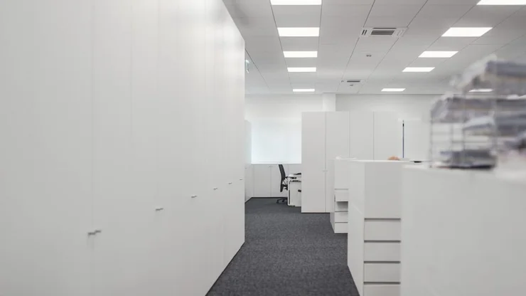 Modern Office Interior with Glass Partitions and Custom Storage